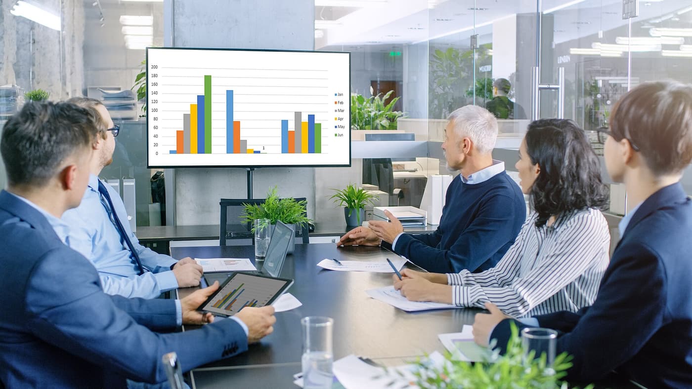 Team reviewing performance analytics in a boardroom